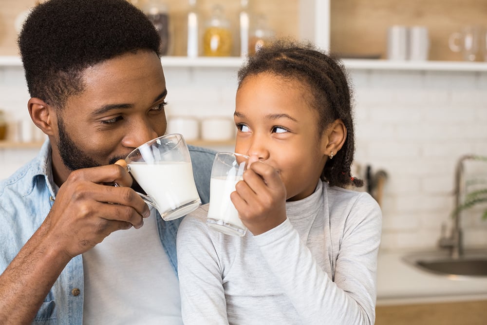 Father and daughter drinking milk