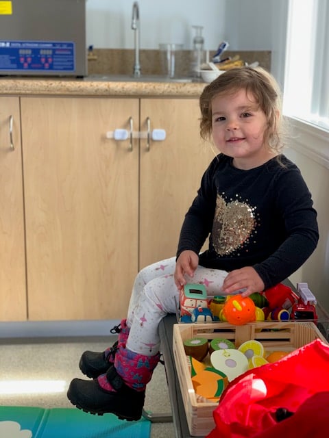 child sitting on chair in office
