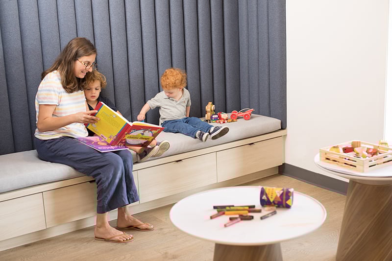 Mom reading to children at a Latitude clinic
