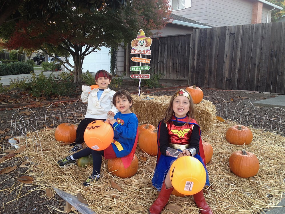 children smiling in halloween costumes