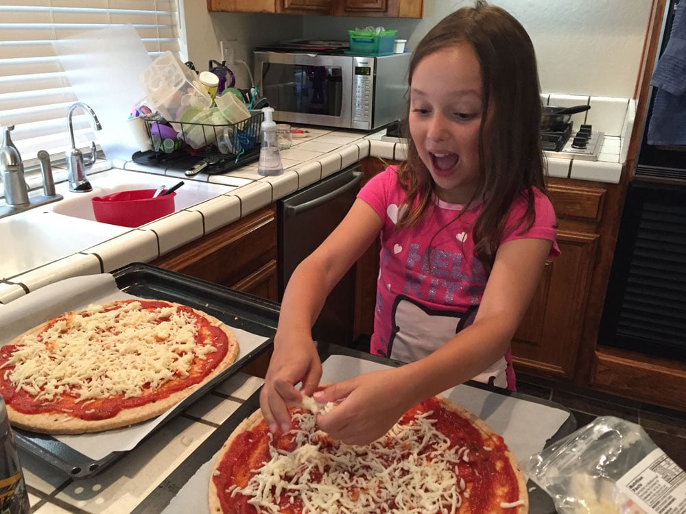 Lilly making pizza